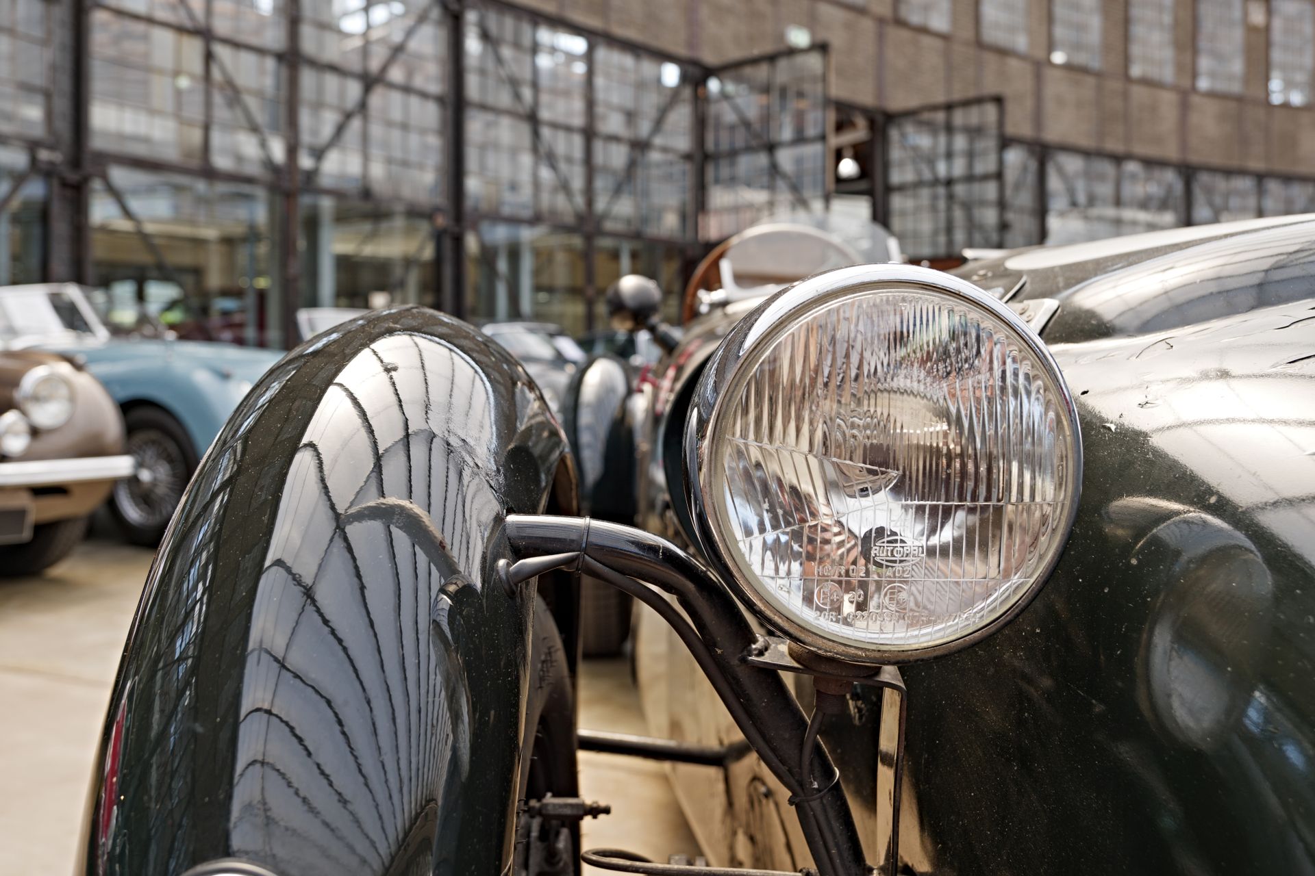 headlight and fender of black old classic and vintage luxury car.